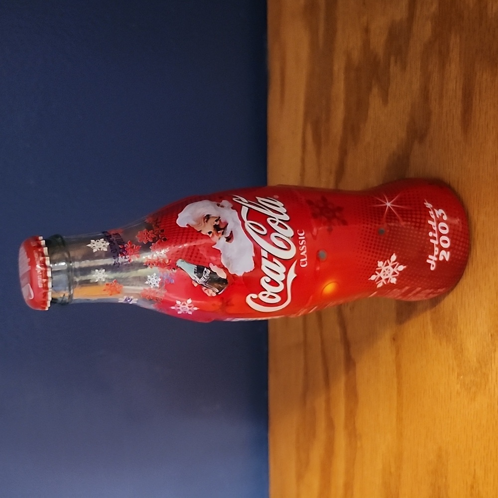 Coca Cola Classic bottle full.  8 FL oz Holiday 2003